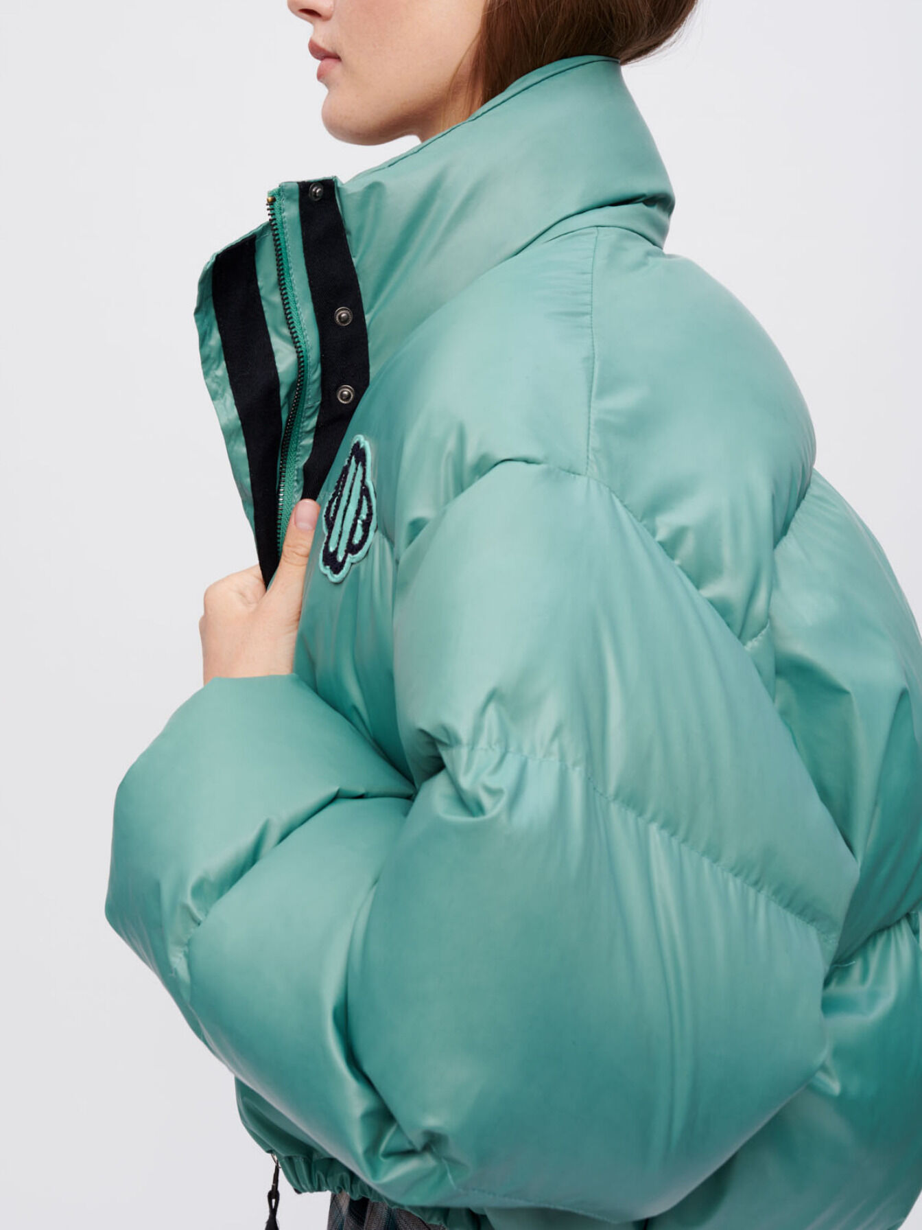 Green down jacket with Maje Clover patch