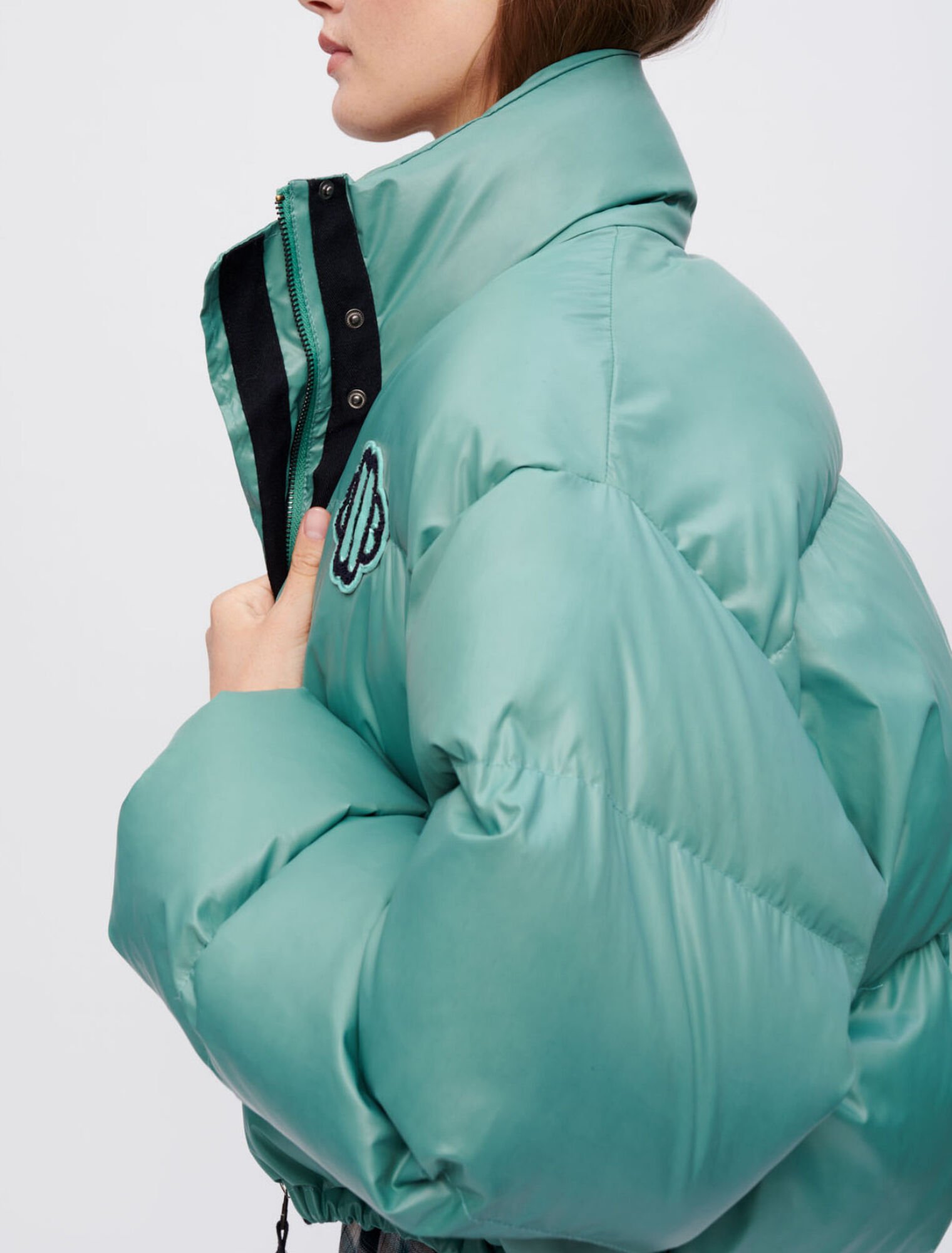 Green down jacket with Maje Clover patch