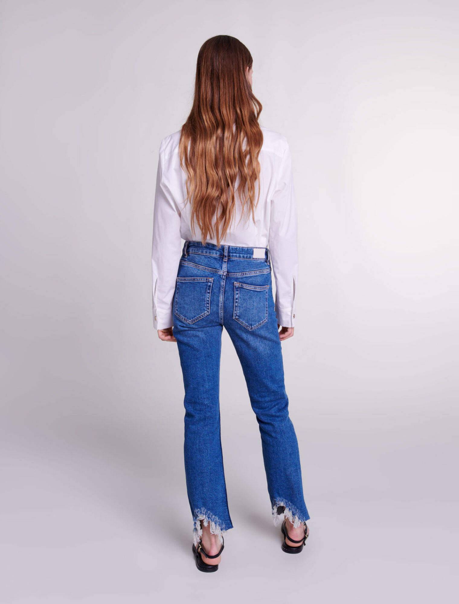 Slim-fit jeans, ripped at the bottom