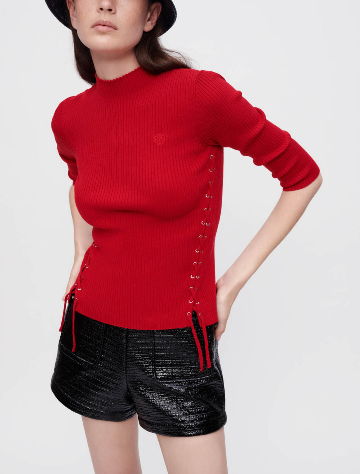 Sweater with silver eyelets