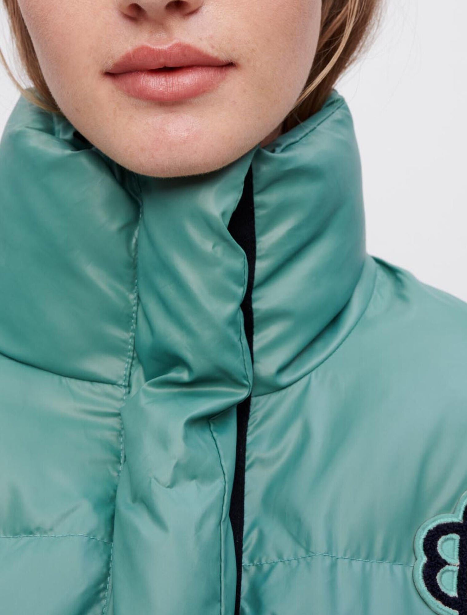 Green down jacket with Maje Clover patch