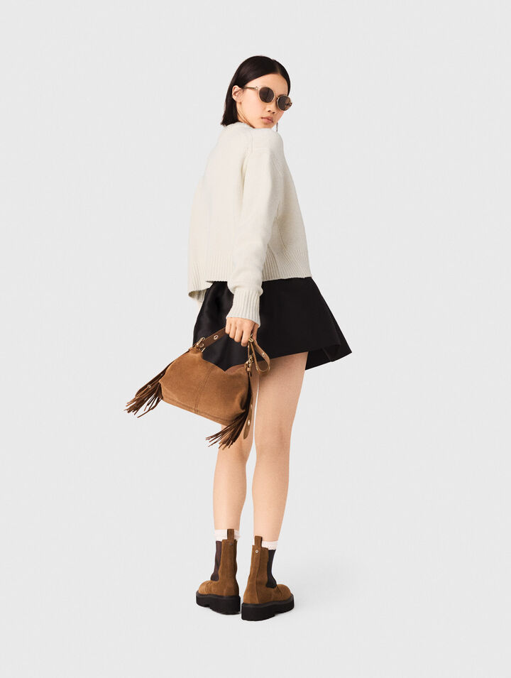 Sweater with floral brooch