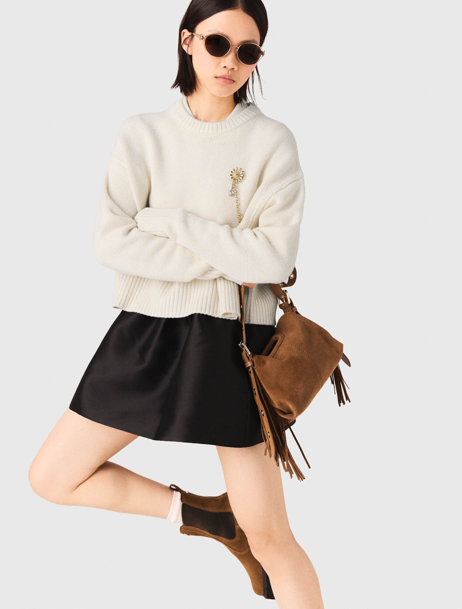 Sweater with floral brooch