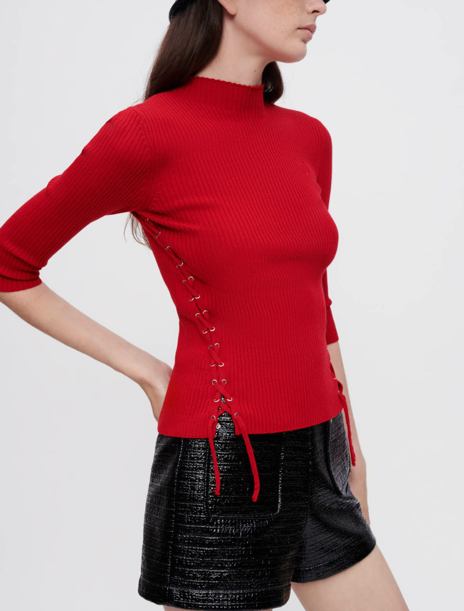Sweater with silver eyelets