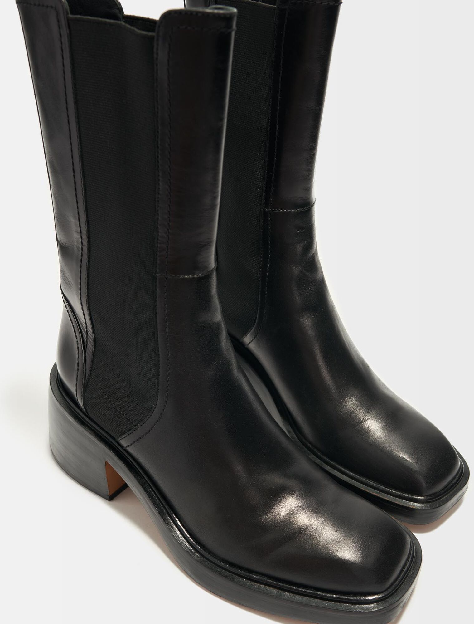 Black leather ankle boots and square toe