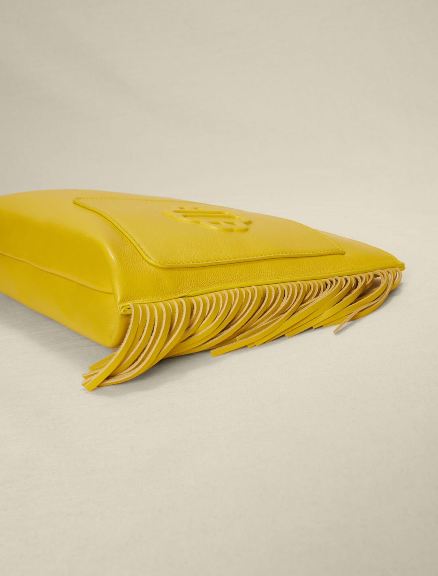 Fringed leather clutch bag