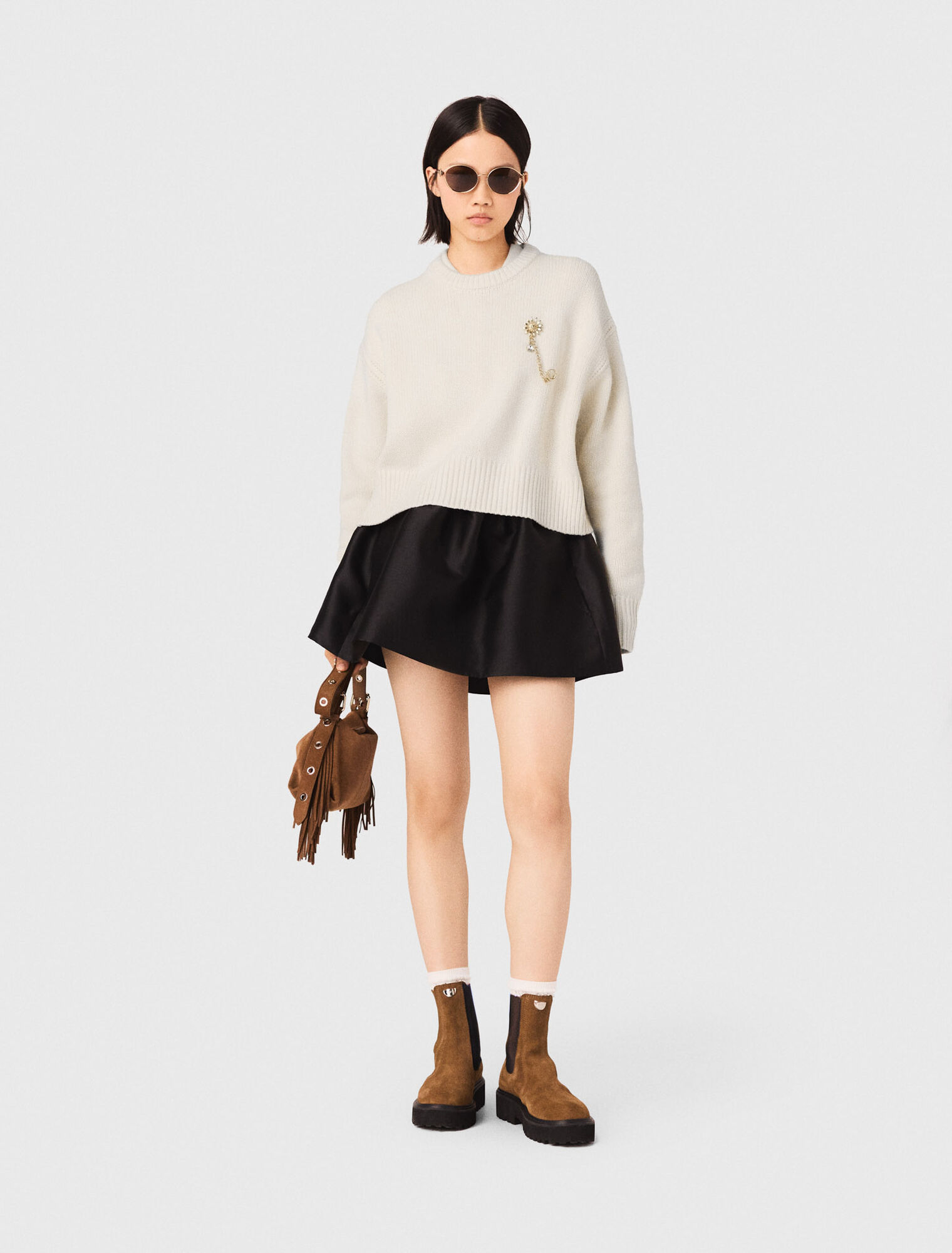 Sweater with floral brooch