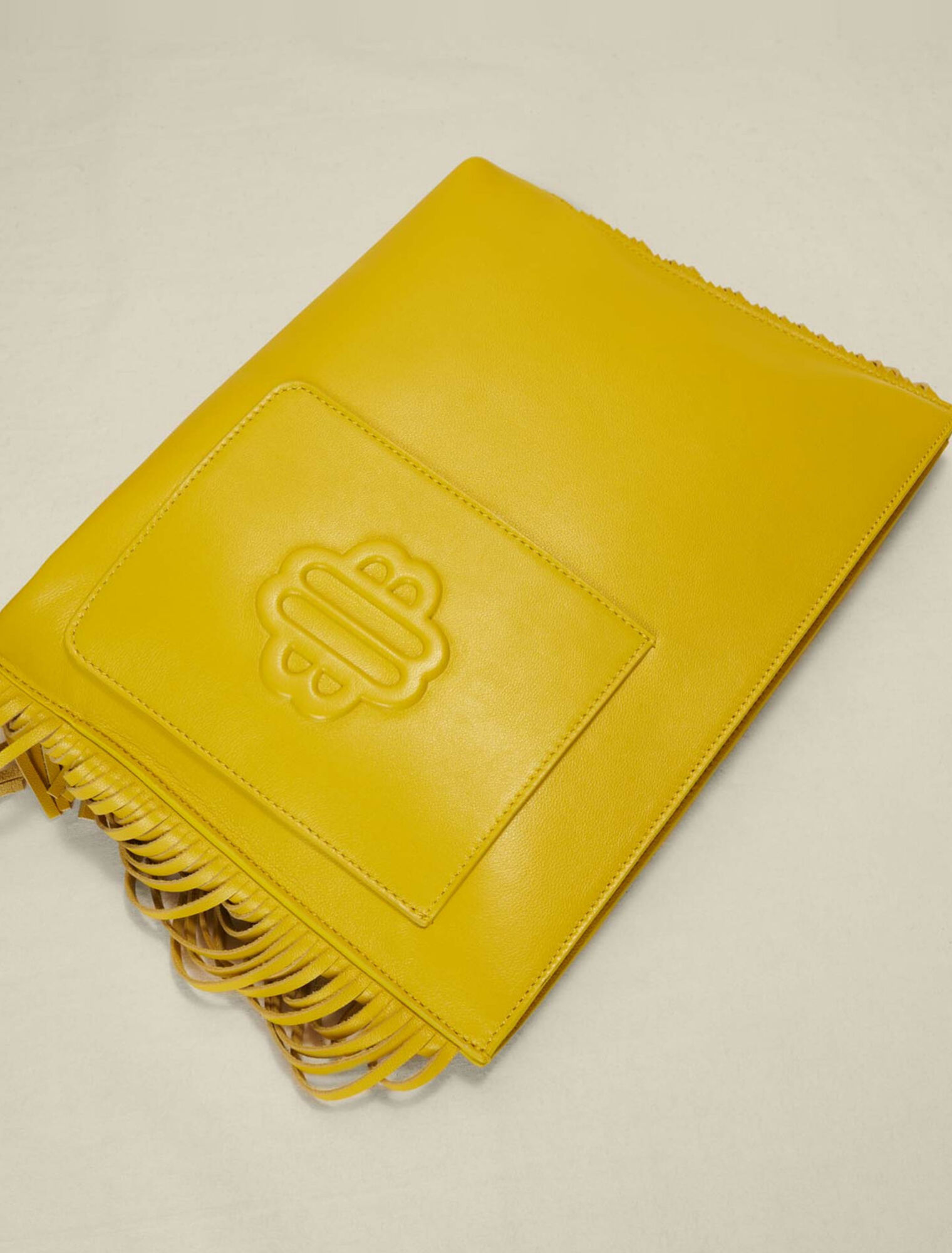 Fringed leather clutch bag