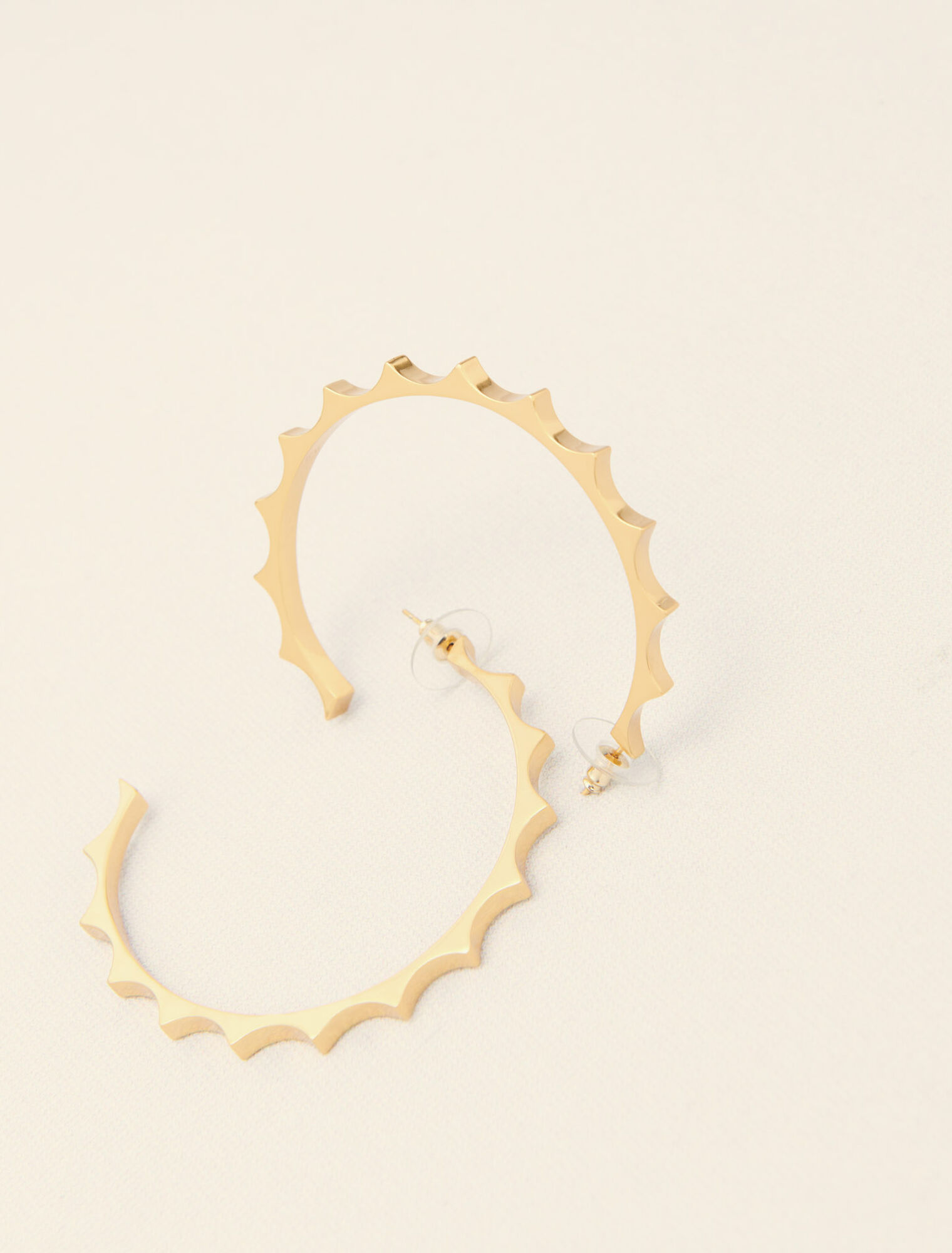 Gold tapered metal hoop earrings