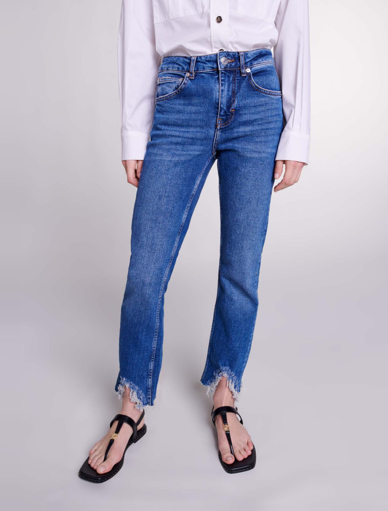 Slim-fit jeans, ripped at the bottom