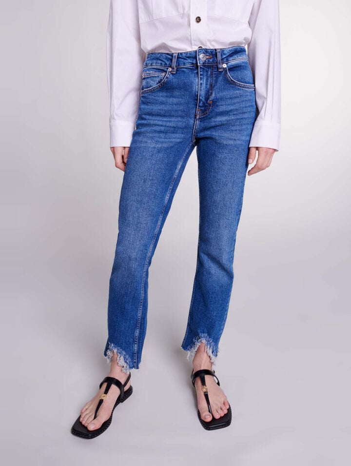 Slim-fit jeans, ripped at the bottom