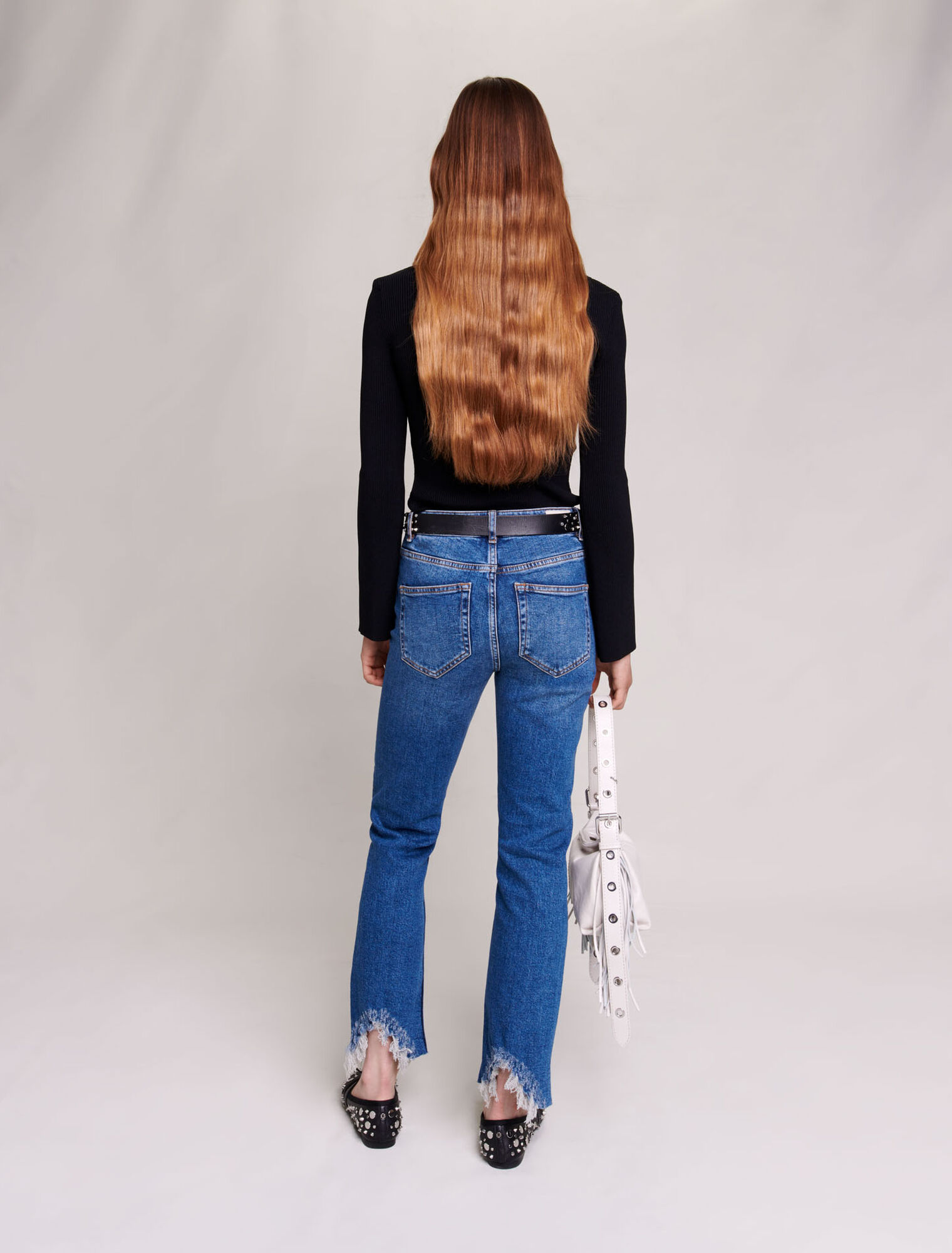 Slim-fit jeans, ripped at the bottom
